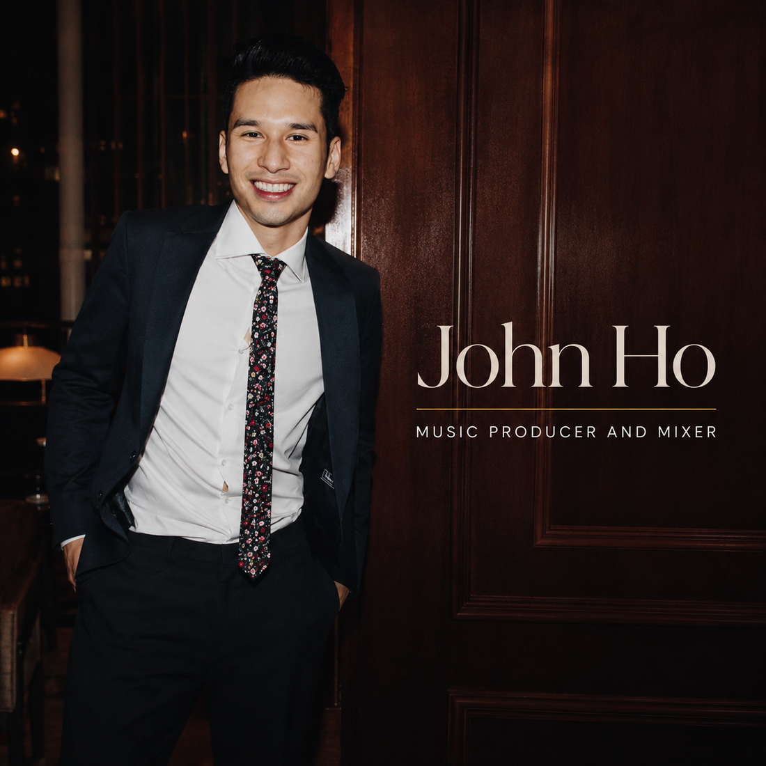 John Ho music producer and mixer wearing a black suit in a premium editorial portrait for his artist profile.