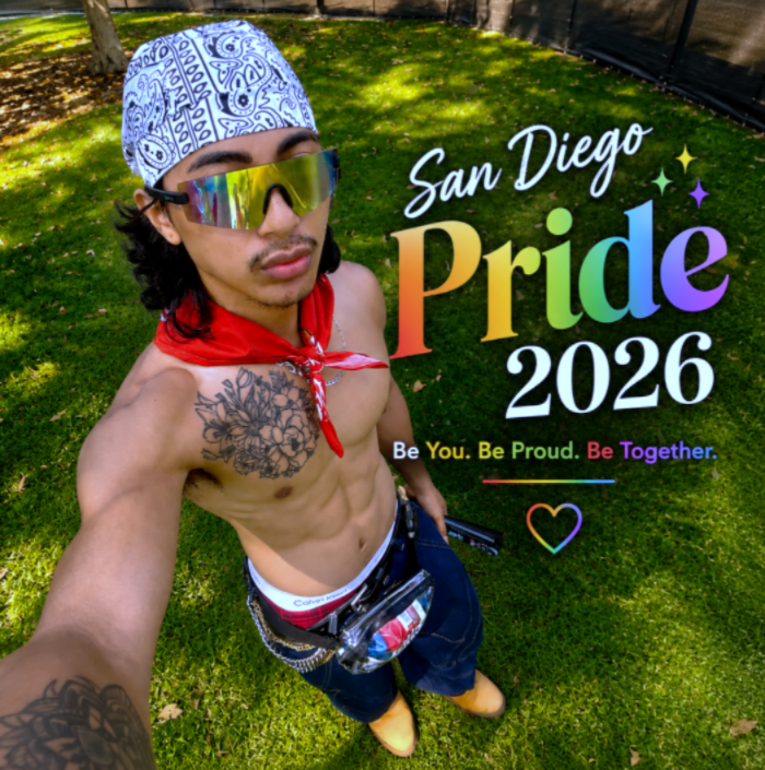 Jeremy Melodious posing outdoors at San Diego Pride Festival 2026 in sunglasses and a red bandana beside rainbow Pride text.